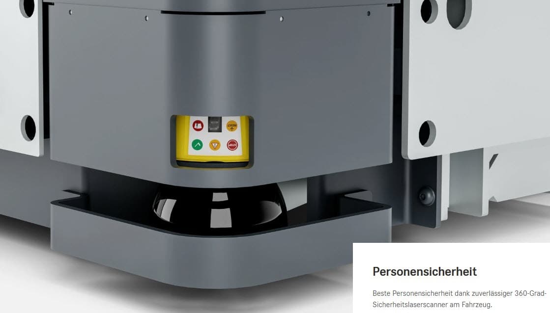 Nahaufnahme des Sockels einer Maschine in einem Lagerhaus mit einem gelben 360-Grad-Sicherheits-Laserscanner und einem sichtbaren Sicherheitswarnschild für Logistikbetriebe.